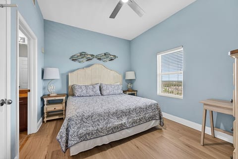 Spacious primary bedroom featuring a king-size bed for a comfortable and relaxing retreat.