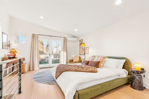 Bedroom 1 with king size bed and ensuite bath, partial lake view in the winter, tree line view in the summer