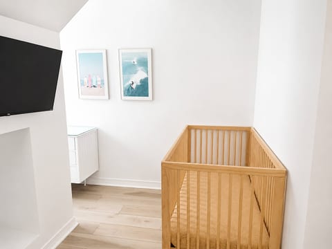 Bright nursery nook with wooden crib and charming coastal decor
