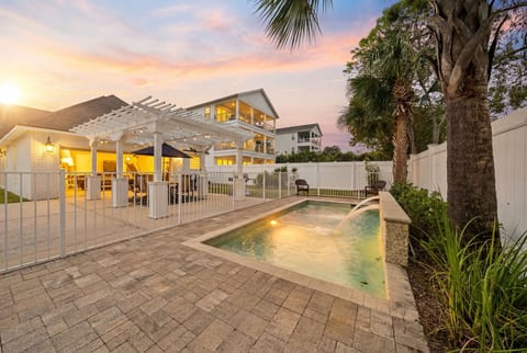 Private plunge pool and pergola patio glowing at sunset