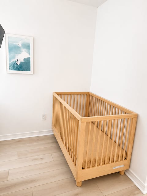 Bright nursery nook with natural wood crib and clean, calming design