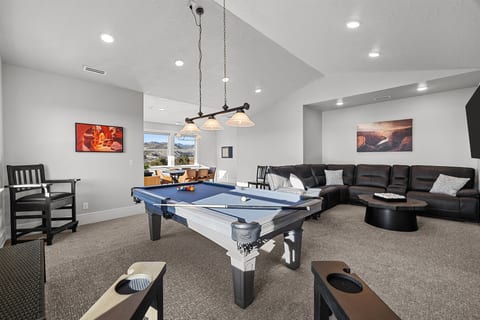 Upstairs game room with pool table and poker table