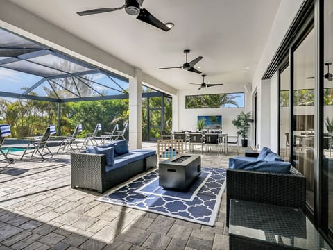 Gather under the covered lanai for meals, games, and poolside lounging in this inviting indoor-outdoor living space.