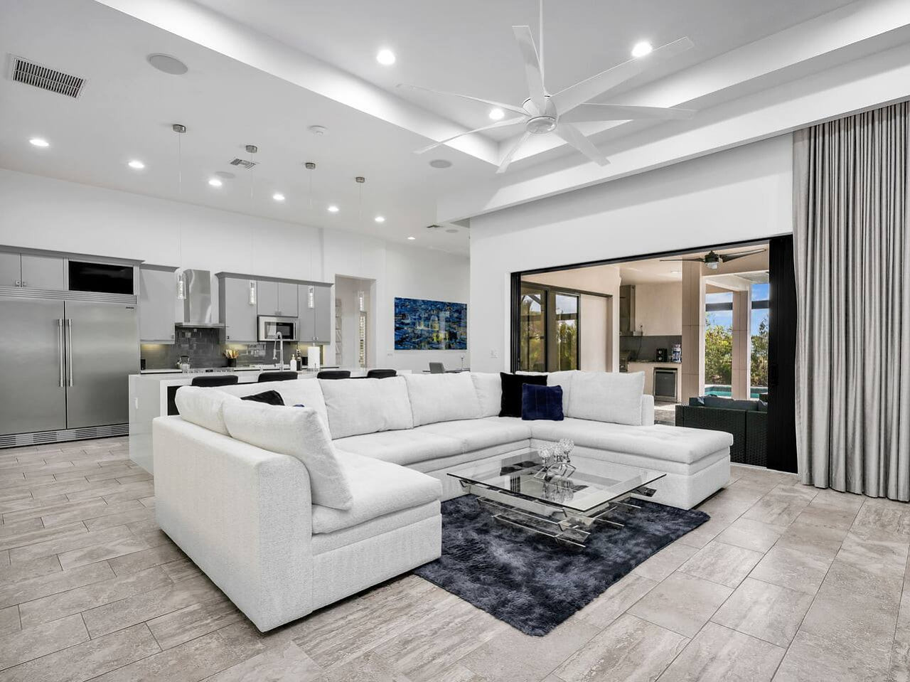 Relax in the bright open living area, designed for gathering, dining, and enjoying effortless access to the lanai.