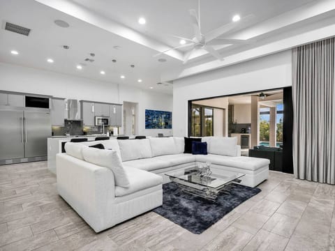Relax in the bright open living area, designed for gathering, dining, and enjoying effortless access to the lanai.