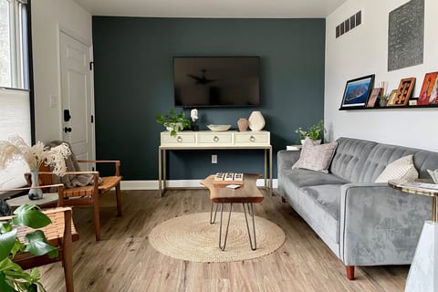 The front living room features a fold down sofa, big smart TV and is right off the kitchen