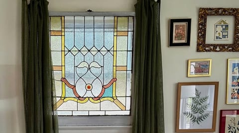 Artisan character just minutes from the beach. Cozy up in a thoughtfully styled living space packed with unique architectural details, curated gallery walls, and sun-kissed historic glass.