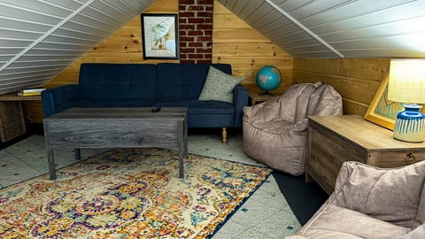 The loft has a convertible sofa, a lift coffee table that can double as a desk or dining, a tv, and a pretty killer view of the apartment from above