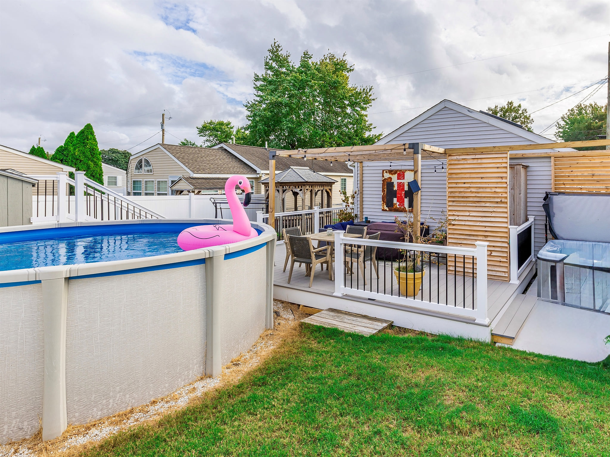 backyard oasis! pool, hot tub, fire table, outdoor shower, dining AND lounge area!