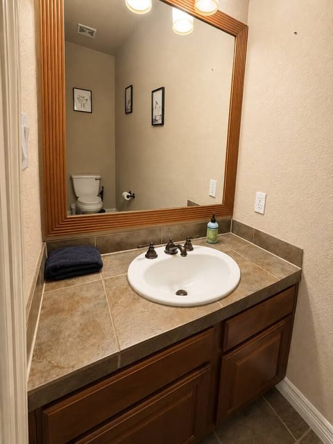 Theater half bathroom with vanity and toilet.