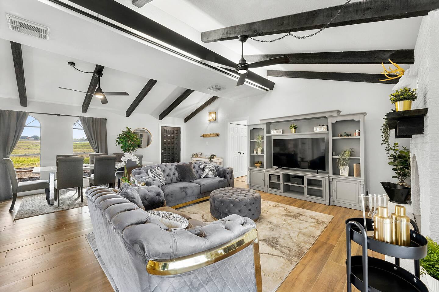Spacious living room with beams and large Smart TV