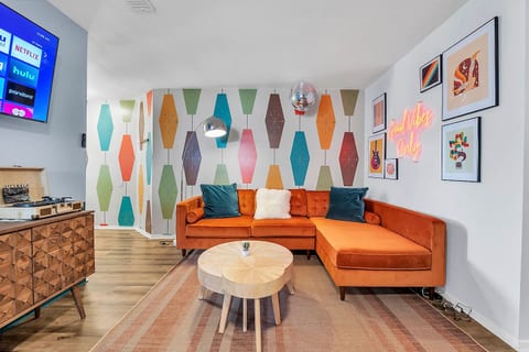 Groovy vibes and far-out charm in this retro-inspired living room - where neon signs and funky patterns take center stage!