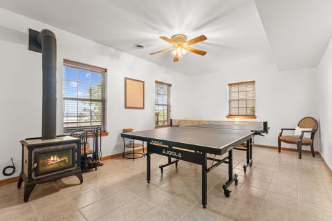 Game room with ping pong table and wood stove. Pull up a chair by the fire and let the paddles fly.