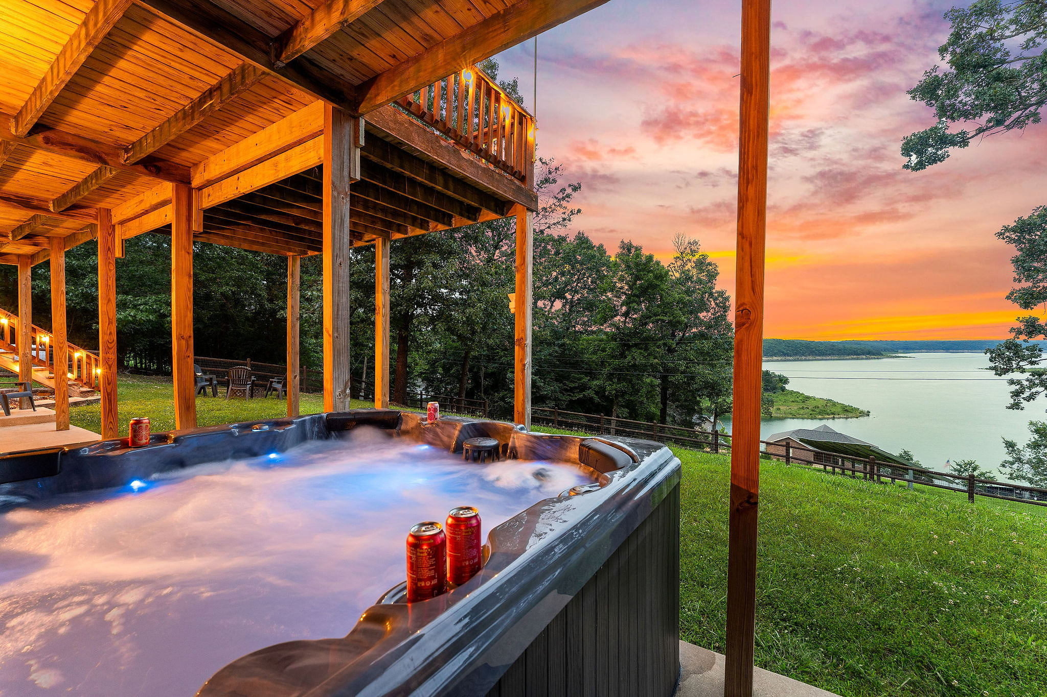 Sink into the bubbling jets as the sky turns orange over Bull Shoals Lake — cold drink on the ledge, steam rising around you. The private hot tub sits on the lower patio, just steps from the fire pit.