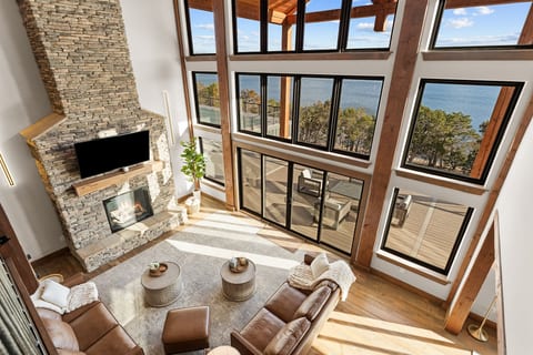 Morning light, lake views, and a crackling stone fireplace—this inviting great room is made for slow mornings, cozy evenings, and unforgettable moments together.