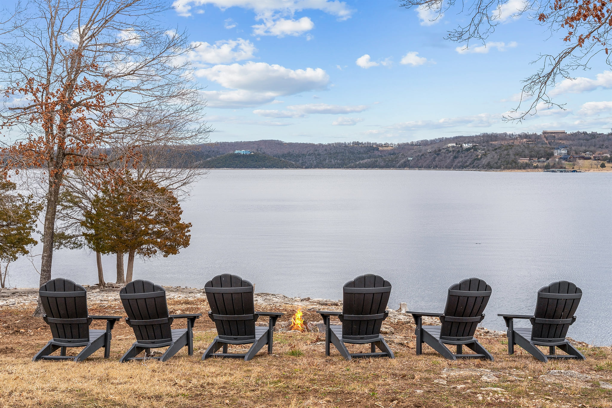 Relax lakeside in Adirondack chairs just steps from the water at this Table Rock Lake retreat.