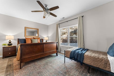 King bed with its own en-suite bath — the master gets the walk-in shower and the privacy. Everyone else has their own room too, but this one's the one people will want to claim first.