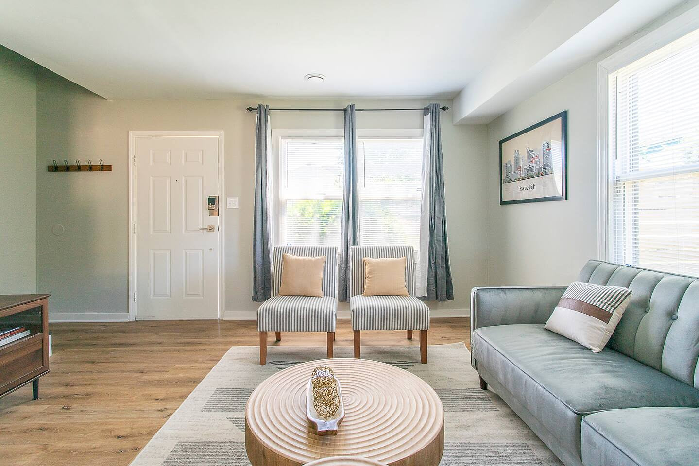 Living Room: Sunlit space with chic seating and modern decor, perfect for relaxation and gathering! 