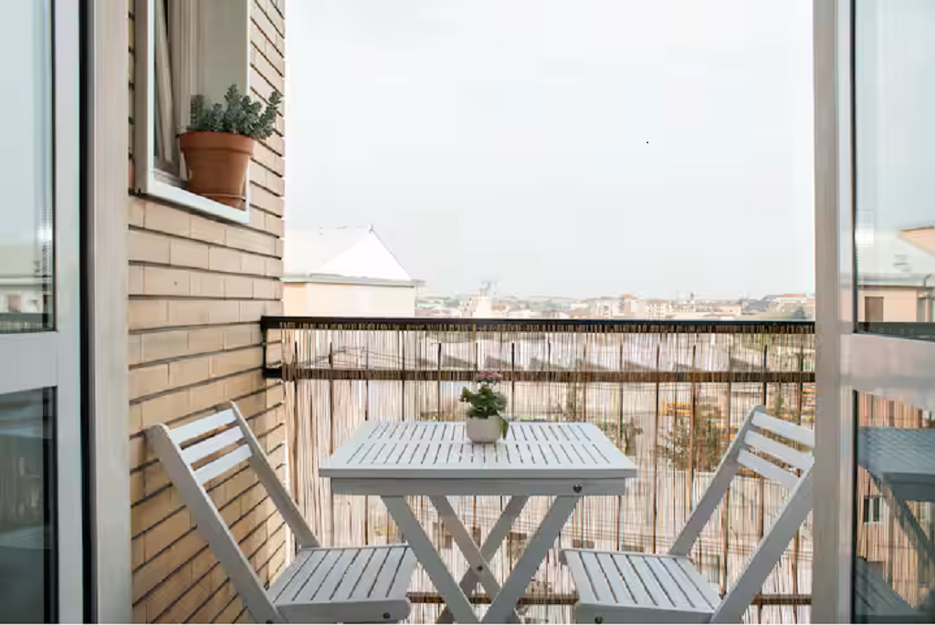 private terrace, outdoor furniture, sunset and city skyline views for coffee and aperitivo