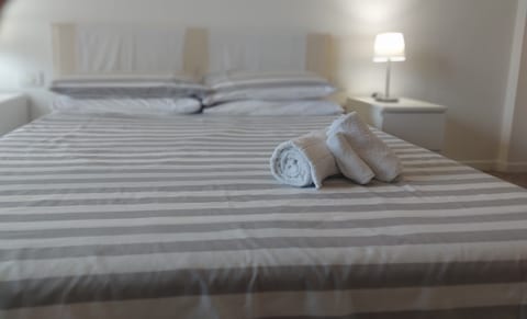 Comfortable spacious bright bedroom with balcony access and extensive wardrobe space