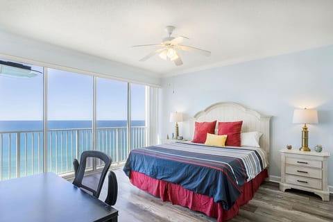 Gulf-front primary bedroom with king bed, balcony access, and stunning ocean views.