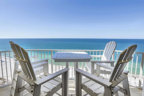 Gulf-front balcony with high-top seating and stunning panoramic ocean views.