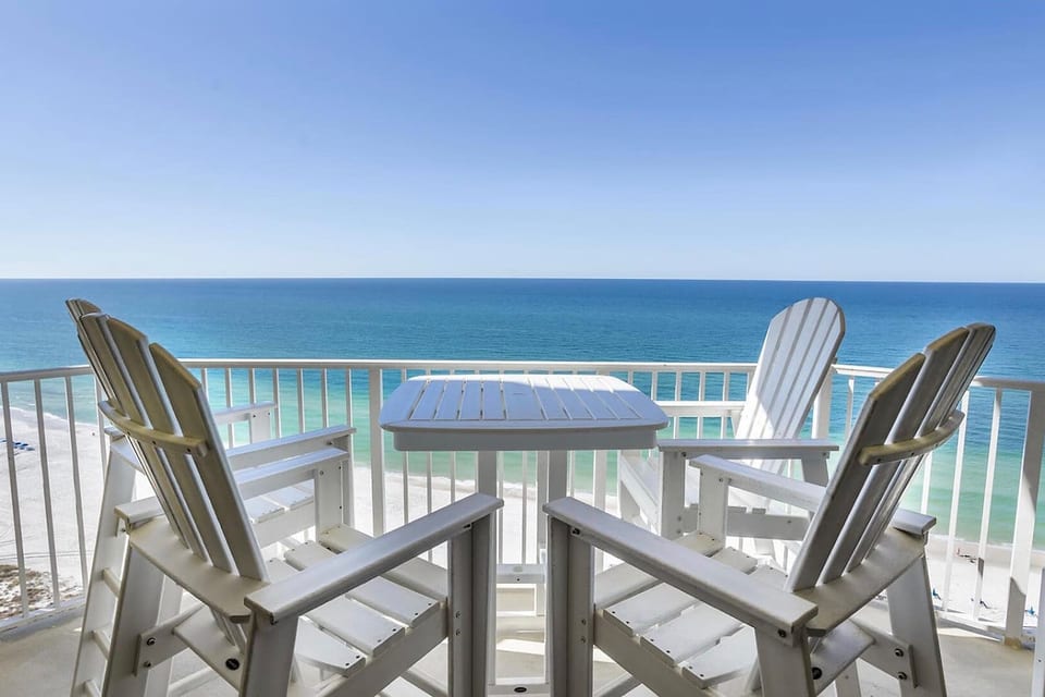 Gulf-front balcony with high-top seating and stunning panoramic ocean views.
