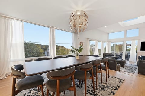 Living and Dining Room with High Ceiling and Panoramic Views of Ocean, Lagoon and Mountains