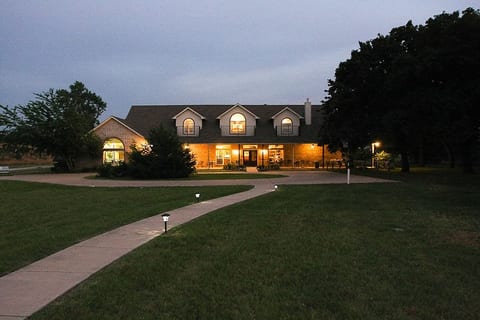 Front view of the Resort style Ranch home during the night