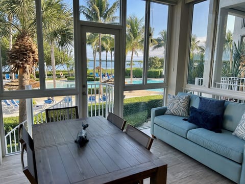 Living area sunroom overlooking the pool with Queen Sleeper Sofa