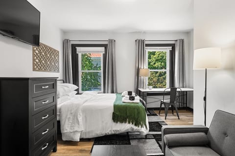 Cozy Bedroom Getaway | Bright natural light and refreshing ambiance make this charming retreat perfect for work or unwinding.