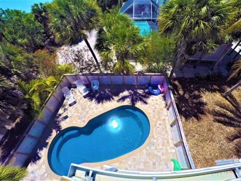 View of the pool and Gulf of Mexico from the upstairs lanai