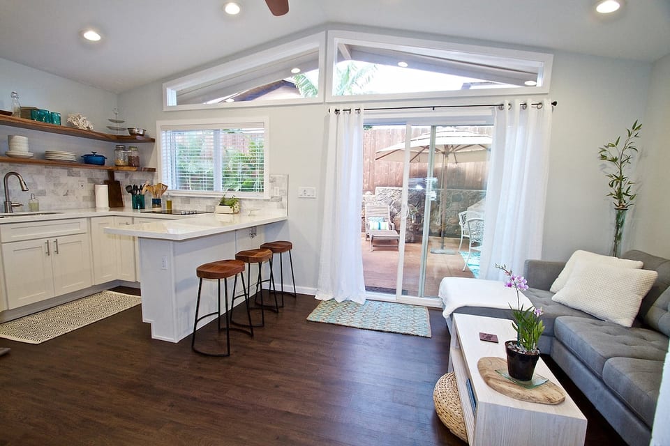 View of the living room, kitchen and patio from the bedroom.