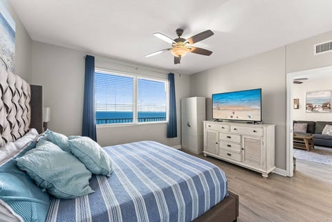 Inviting bedroom with a king bed, coastal décor, and plenty of natural light.