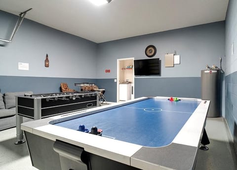 The garage has been converted into a games room with air hockey and table football