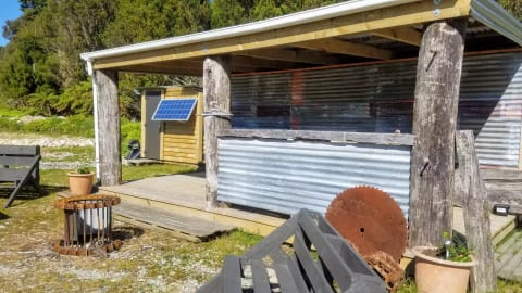 Cooking shelter and shower with solar panel.