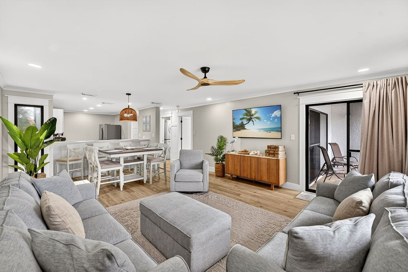 nviting living and dining space with coastal décor and easy access to the private balcony.