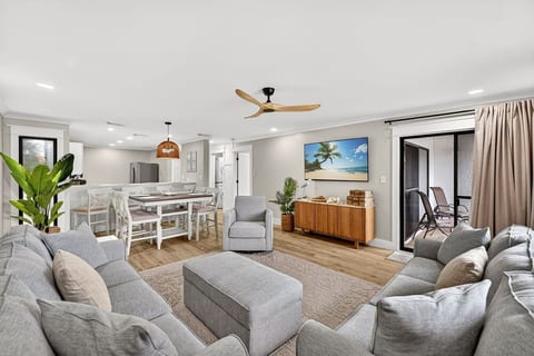 nviting living and dining space with coastal décor and easy access to the private balcony.