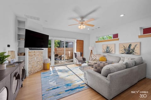 Cozy living area with new 65-inch Smart TV and sliding doors to the private patio. Perfect for movie nights, game days, or slow mornings with coffee.