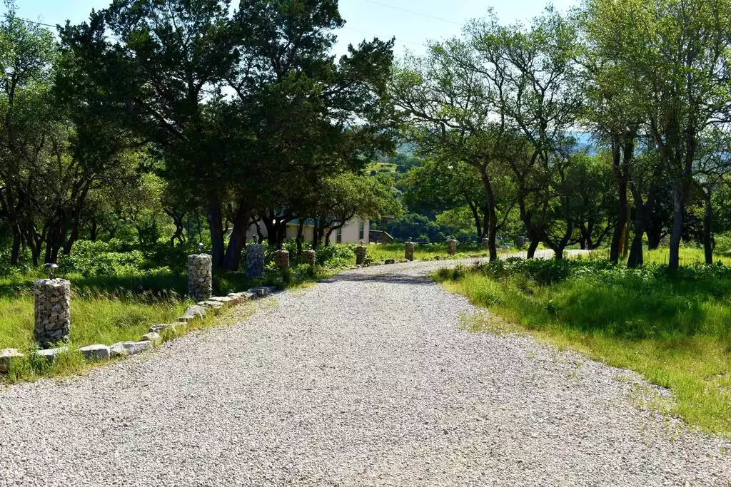 Road down to the cabin, accessible by requested UTV or 4 wheel drive vehicles.   The gabbions light up at night giving the pathway walking light. - GWR-Private-AmazingHilltopView-HotTub-FirePit-Pool - Fredericksburg