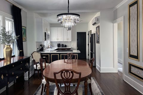 Art Deco dining area flows into the modern kitchen with period details.