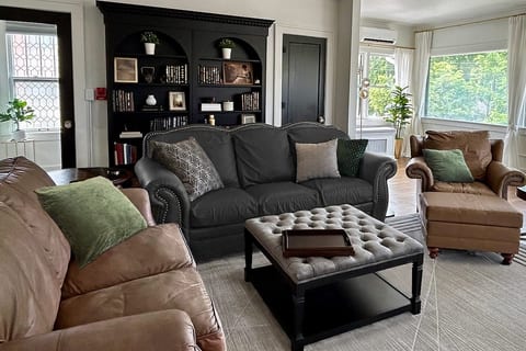 Designed for both relaxation and functionality, the spacious living room features custom built-ins and a thoughtful mix of vintage and modern furnishings.