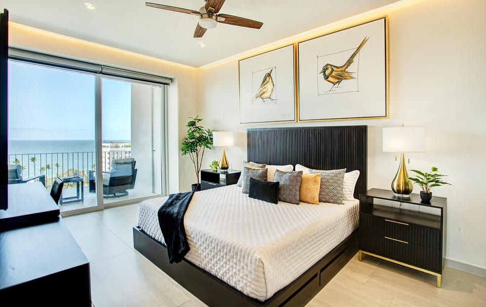 Primary Bedroom: Sliding doors, ocean breeze, breathtaking views — and a bed so comfortable and beautifully appointed you'll have a hard time choosing between the balcony and sleeping in. The primary bedroom is pure indulgence from every angle.