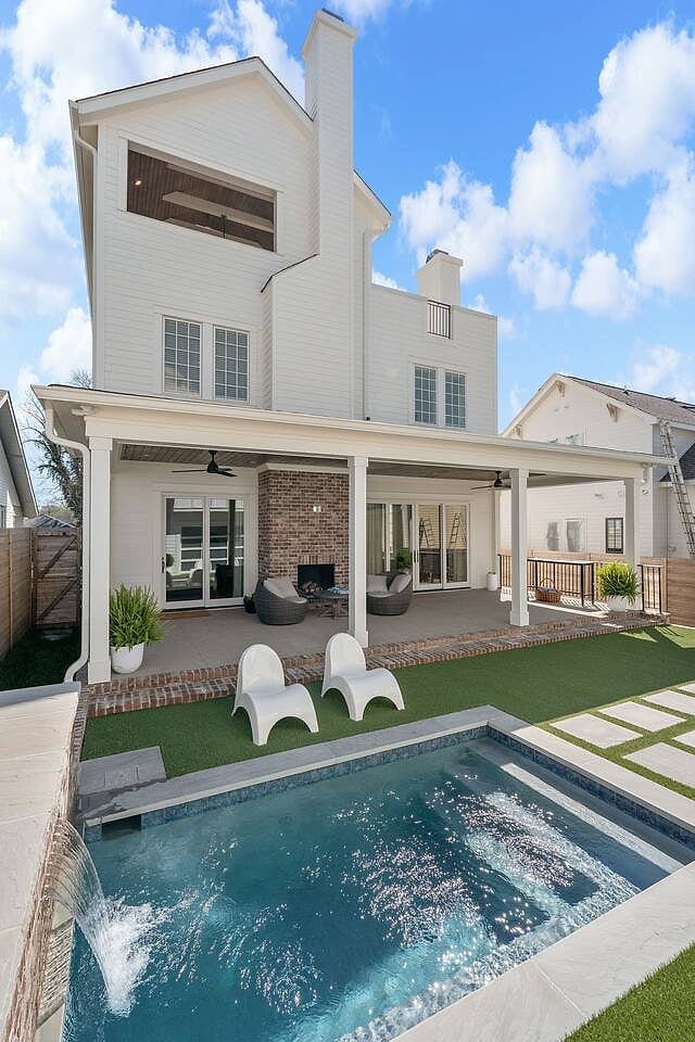 Stunning backyard oasis with sparkling pool, covered patio, and modern outdoor lounge — your private retreat in Nashville.