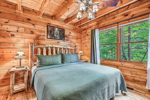Cozy log cabin bedroom with forest views and rustic lodge charm