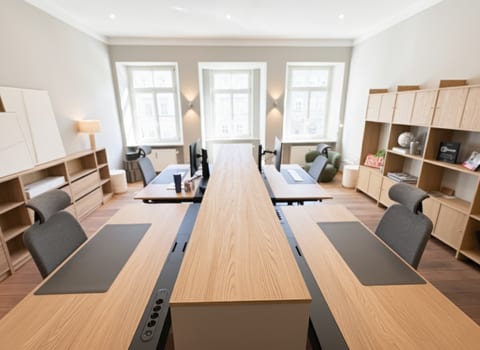 Sunny dedicated office with 4 desks, monitors, and ample storage