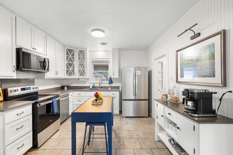 Fully equipped kitchen with elevated finishes, ready for slow mornings in with plenty of coffee