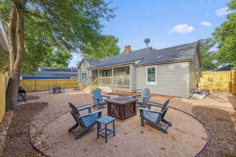 Private fenced backyard with a gas fire pit and lounge seating for easy evenings