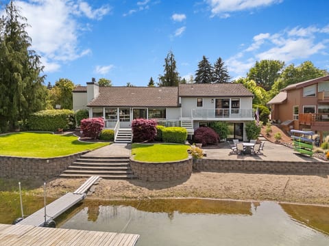 Waterfront retreat with private dock, patio, and beautifully landscaped yard