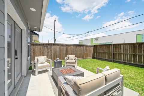 Private fenced backyard with patio seating and cozy fire pit